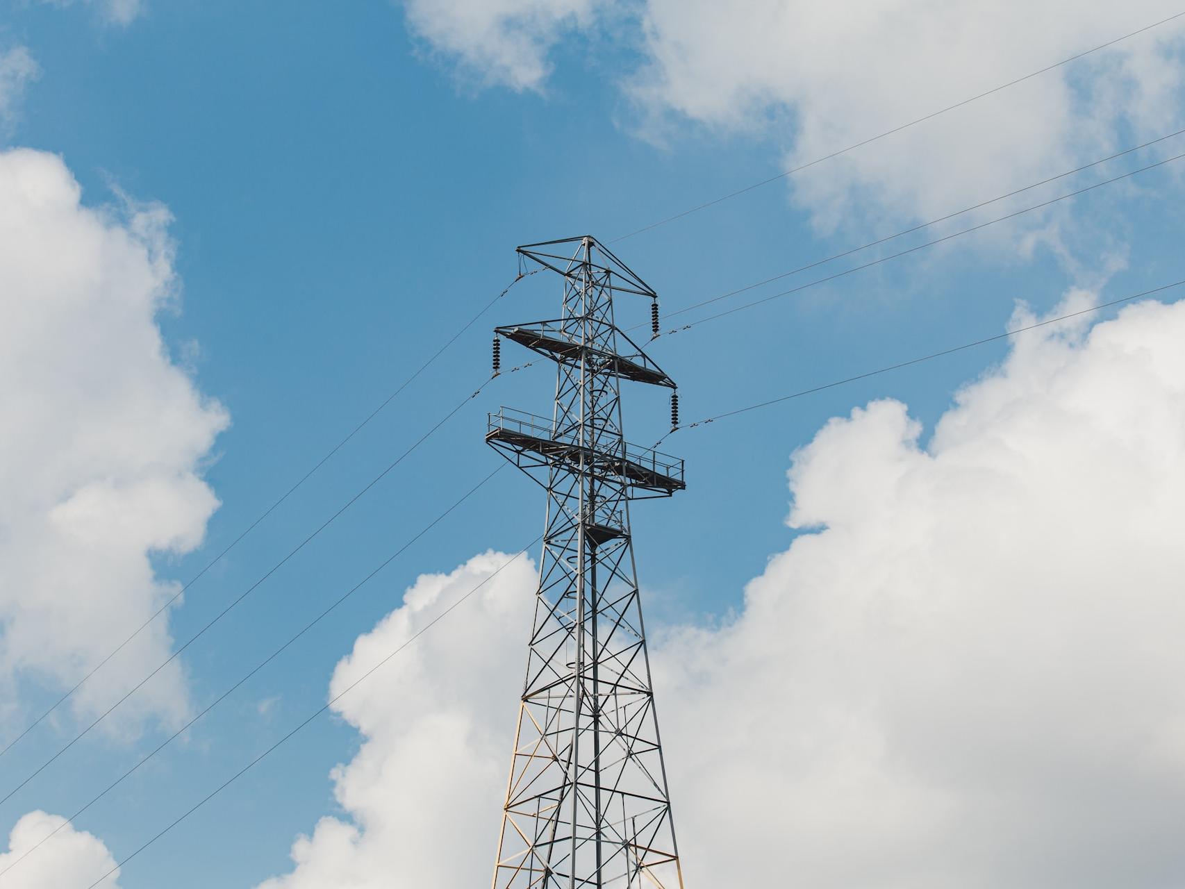 black metal tower under blue sky and white clouds during daytime